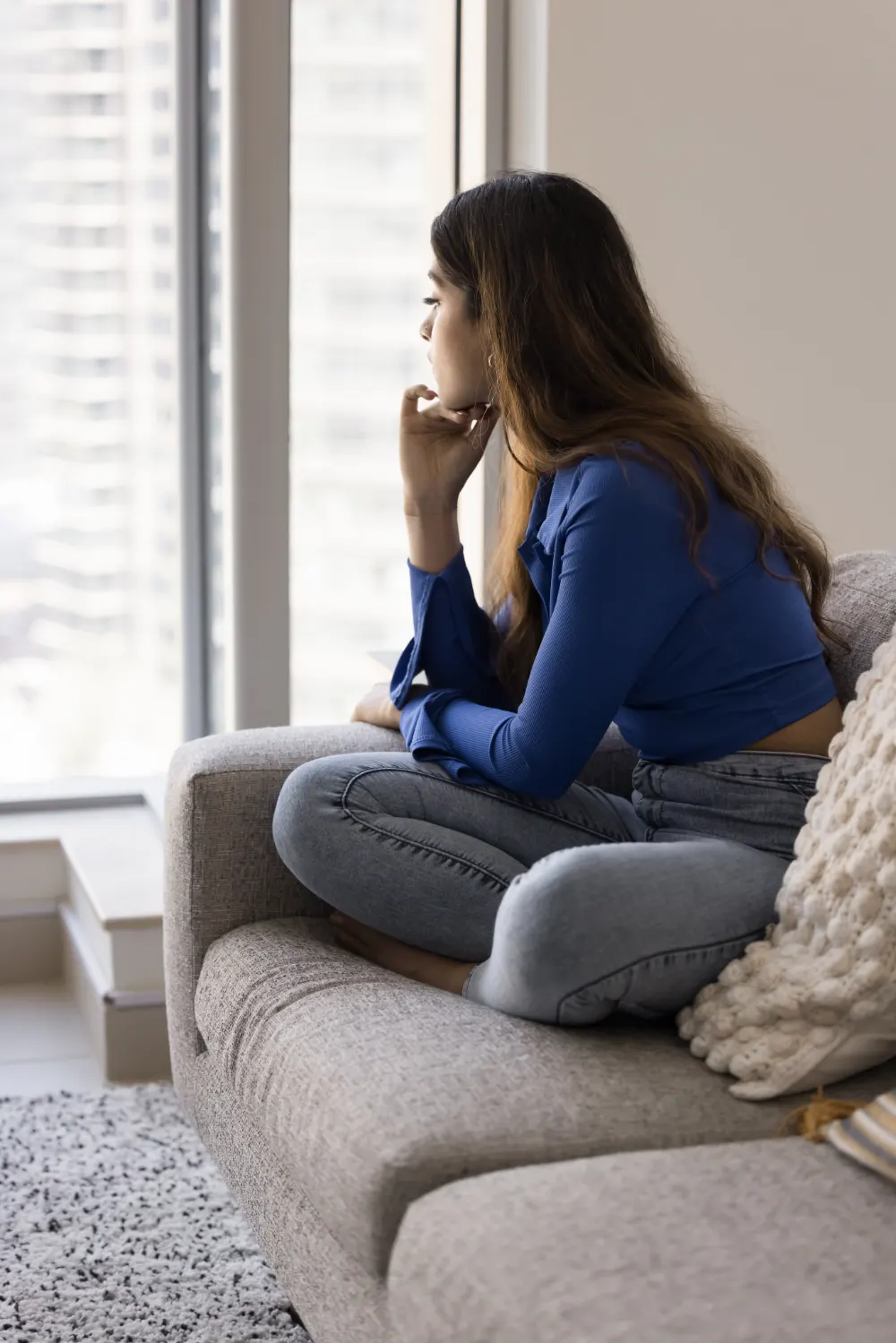 Pensive woman looking out window