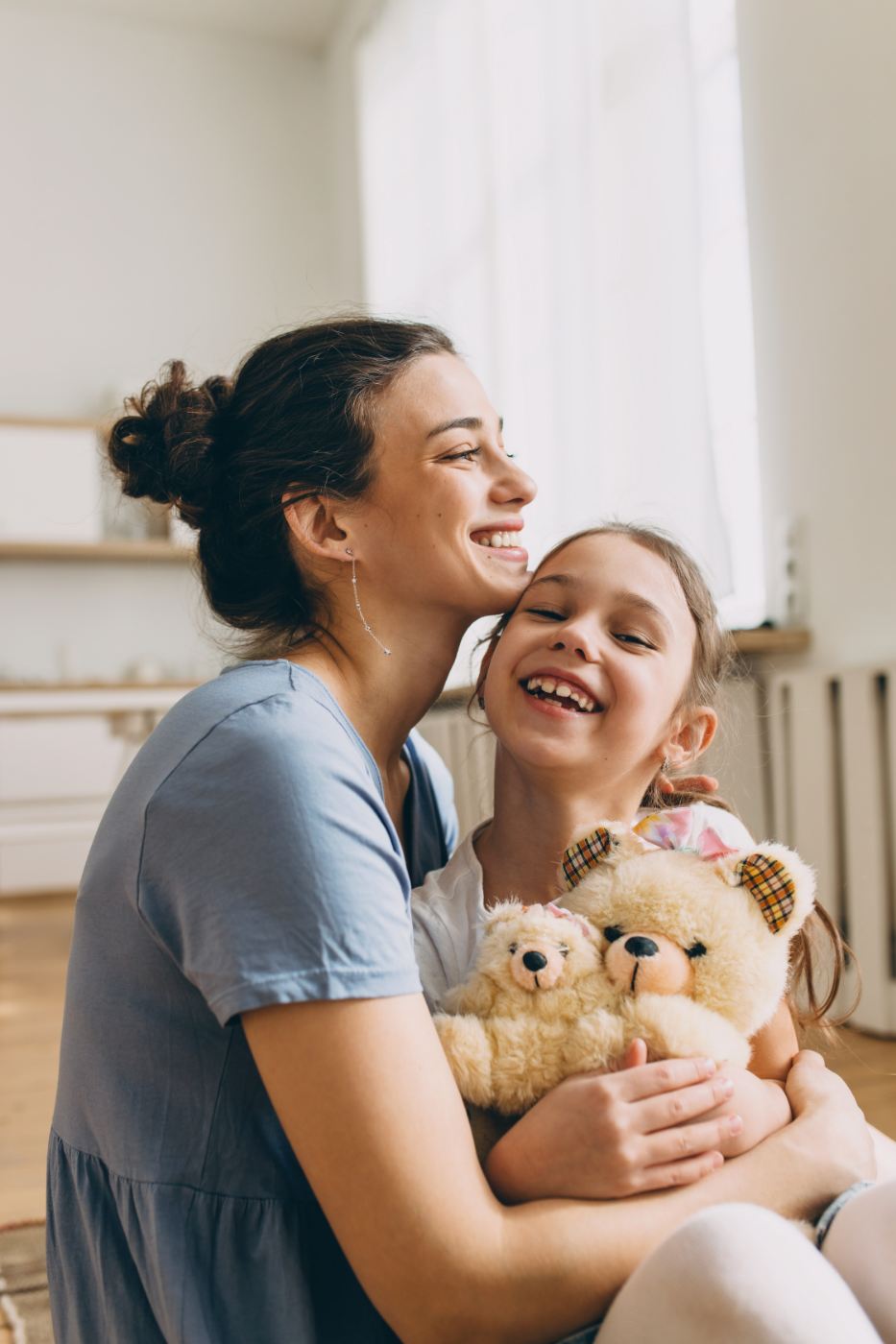 Happy mother embracing young daughter after autism assessment for children.